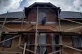 Insulation of the house with facade bricks, construction of a new house and scaffolding near the walls Royalty Free Stock Photo