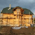 Insulation of the house with facade bricks, construction of a new house and scaffolding near the walls Royalty Free Stock Photo