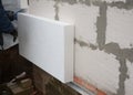 Insulation house wall outdoors. Builder installing rigid styrofoam insulation board for energy saving. Rigid extruded polystyrene