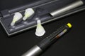 Insulin pen with needles. Selective focus close up on black background. Medical devices are used for self-use in the Royalty Free Stock Photo