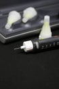 Insulin pen with needles. Selective focus close up on black background. Medical devices are used for self-use in the Royalty Free Stock Photo