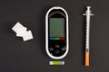 Insulin syringe glucometer and white sugar cubes