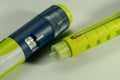 Insulin syringe or injector of pen model with dose setting knob and scale window and a one time throw away needle in bright yellow