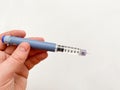 Insulin syringe-pen in hand on a white  background. Insulin for diabetics Royalty Free Stock Photo