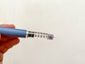 Insulin syringe-pen in hand on a white isolated background. Insulin for diabetics Royalty Free Stock Photo
