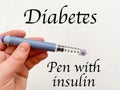 Insulin syringe-pen in hand on a white isolated background. Insulin for diabetics Royalty Free Stock Photo