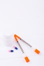 Insulin syringes, two capsules and plastic bottle on white background Royalty Free Stock Photo