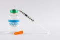 Insulin in vial and uncapped syringe on white background Royalty Free Stock Photo