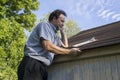 Insurance Adjuster Checking Roof For Hail Damage Royalty Free Stock Photo