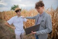 Insurance agent argues with his client farmer in the fields, angry farmer about the drought