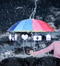Insurance agent covering illustrations with umbrella during storm Royalty Free Stock Photo