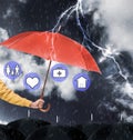 Insurance agent covering illustrations with umbrella during storm Royalty Free Stock Photo