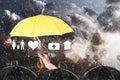 Insurance agent covering illustrations with umbrella during storm Royalty Free Stock Photo