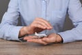 Insurance agent covering toy plane at table, closeup. Travel safety