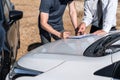Insurance Agent and customer assessed negotiation, checking and signing on report claim form process after accident collision, Royalty Free Stock Photo