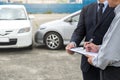 Insurance Agent examine Damaged Car and customer filing signature on Report Claim Form process after accident, Traffic Accident Royalty Free Stock Photo