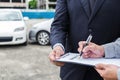 Insurance Agent examine Damaged Car and customer filing signature on Report Claim Form process after accident, Traffic Accident Royalty Free Stock Photo