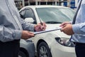 Insurance Agent examine Damaged Car and customer filing signature on Report Claim Form process after accident, Traffic Accident Royalty Free Stock Photo