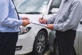 Insurance Agent examine Damaged Car and customer filing signature on Report Claim Form process after accident, Traffic Accident Royalty Free Stock Photo