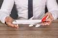 Insurance agent holding toy plane at table, closeup. Royalty Free Stock Photo