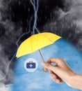 Insurance agent protecting medical kit illustration with yellow umbrella from thunderstorm