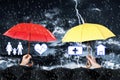 Insurance agents covering with umbrellas during storm