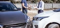 Insurance agents inspect for damage to cars that collide on the road to claim compensation from driving accidents Royalty Free Stock Photo