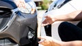 Insurance agents inspect for damage to cars that collide on the road to claim compensation from driving accidents Royalty Free Stock Photo