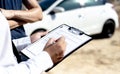 Insurance agents inspect for damage to cars that collide on the road to claim compensation from driving accidents Royalty Free Stock Photo