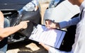 Insurance agents inspect for damage to cars that collide on the road to claim compensation from driving accidents Royalty Free Stock Photo