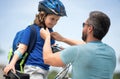 Insurance child. Father teaching son cycling on bike. Father learn little son to ride a bicycle. Father support and Royalty Free Stock Photo