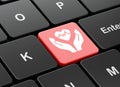 Insurance concept: Heart And Palm on computer keyboard background Royalty Free Stock Photo