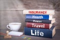 Insurance concept. Stack of books on wooden desk Royalty Free Stock Photo