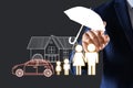 Insurance concept - umbrella demonstrating protection. Man using virtual screen with illustrations Royalty Free Stock Photo