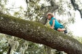 Insurance kids. Kid climbing a tree sitting on tree branch. Health care insurance concept for family and children