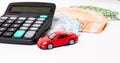 Insurance, loan and buying car concept. Red car and euro banknotes. Calculator, euro money and red car. Copy space for text. Royalty Free Stock Photo