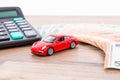 Insurance, loan and buying car concept. Red car and euro banknotes. Calculator, euro money and red car. Copy space for text. Royalty Free Stock Photo