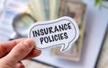 Insurance Policies text on sticker with pen in hand the Office background Royalty Free Stock Photo