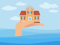 Insurance. Protection of real estate from natural disasters. Insure property against flooding. Hand holding building