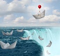 Insurance protection and risk aversion security symbol as paper boats in peril with one saved by a balloon as a coverage assurance Royalty Free Stock Photo