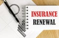 INSURANCE RENEWAL text on notebook with pen and chart Royalty Free Stock Photo