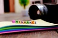 INSURANCE word block on note pad over soft focus background Royalty Free Stock Photo
