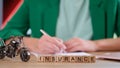 Insurance word on wooden cubes in row, insurance broker on background