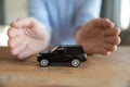 Insurer protecting auto with hands, car insurance coverage services concept