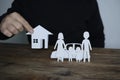 Insurer protecting house, family and car with his hands Royalty Free Stock Photo