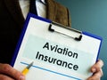 Insurer shows aviation insurance and a pen for signing.