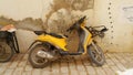 Intage yellow motorcycle in old town located in Djerba Island in Tunisia. Royalty Free Stock Photo