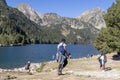 Intarnational tourists by the Sant Maurici mountain lake in the Aiguestortes i Estany de Sant Maurici National Park, Lleida, Spain Royalty Free Stock Photo