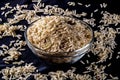 Integral rice on glass bowl isolated on black background