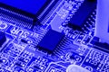 Integrated semiconductor microchip on blue circuit board representative of the high tech industry and computer science Royalty Free Stock Photo